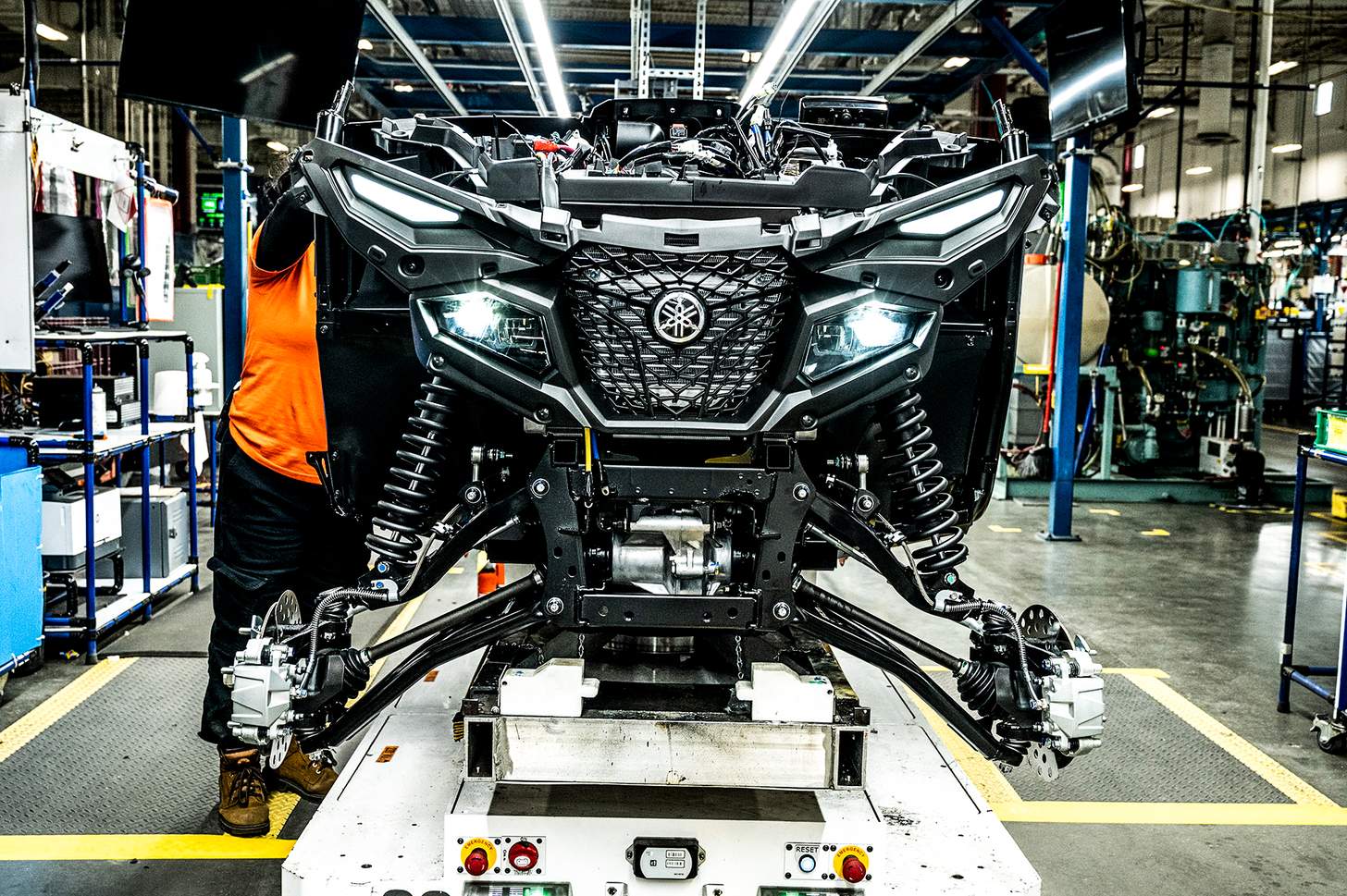Yamaha assembly line partially constructed Grizzly with headlights on
