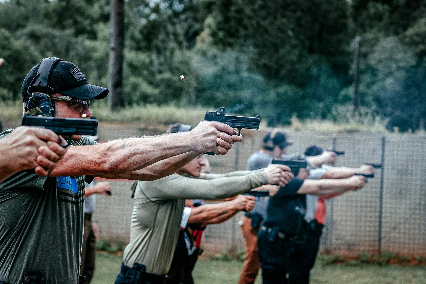 row of shooters with Ruger RXM handgun pistols