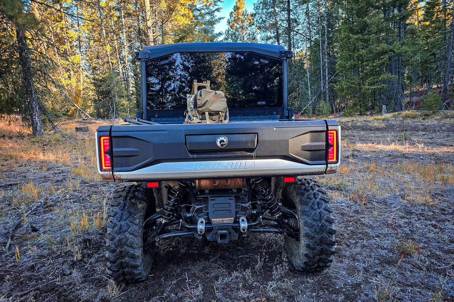 Can-Am Defender from the rear with a hunting pack in the bed