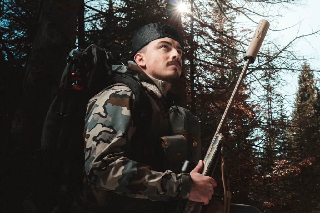Hunter with Dead Air Nomad Ti OTB suppressed hunting rifle