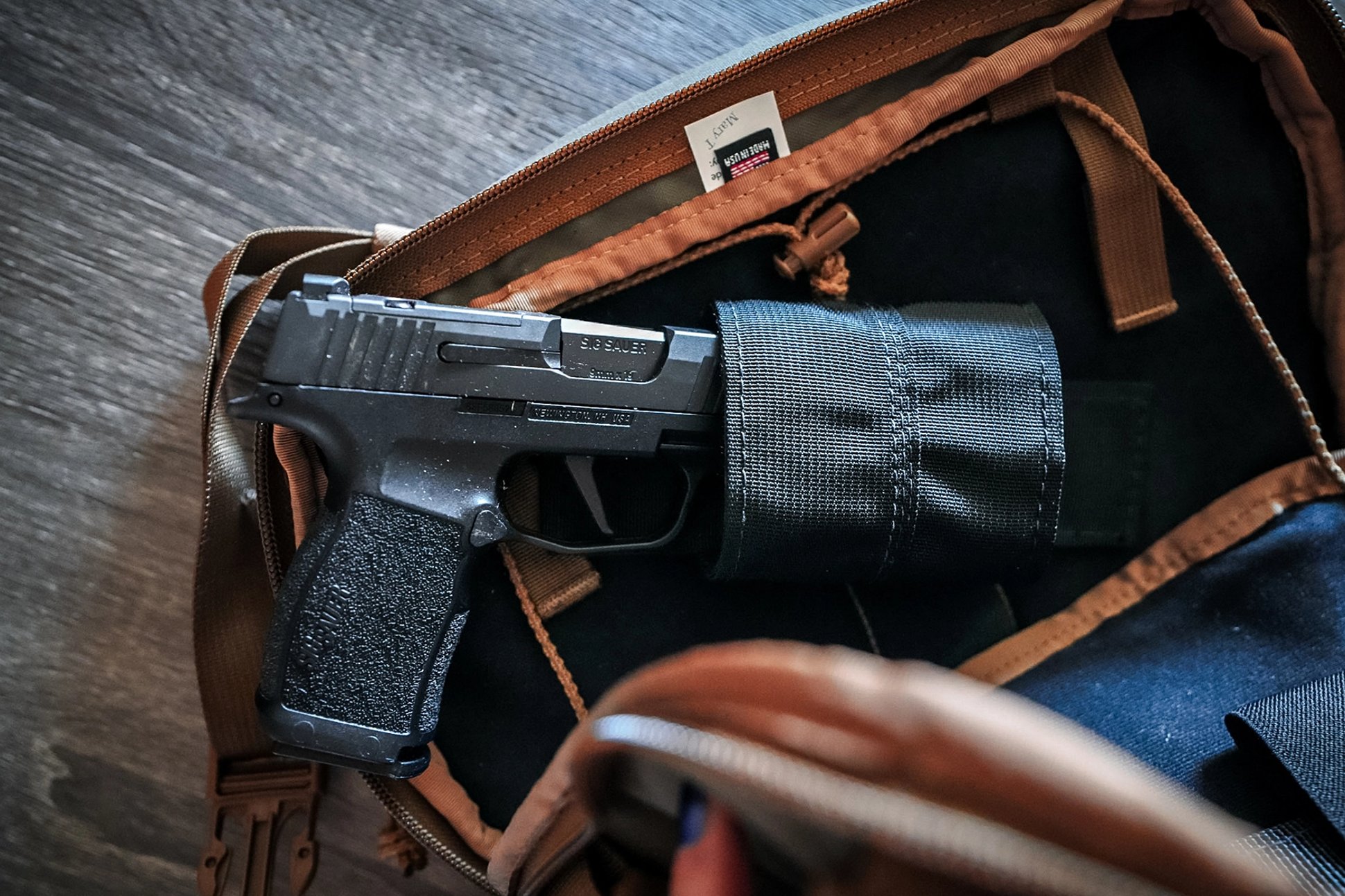 A SIG SAUER P365X Handgun holstered in a Kifaru Steelhead Chest Rig