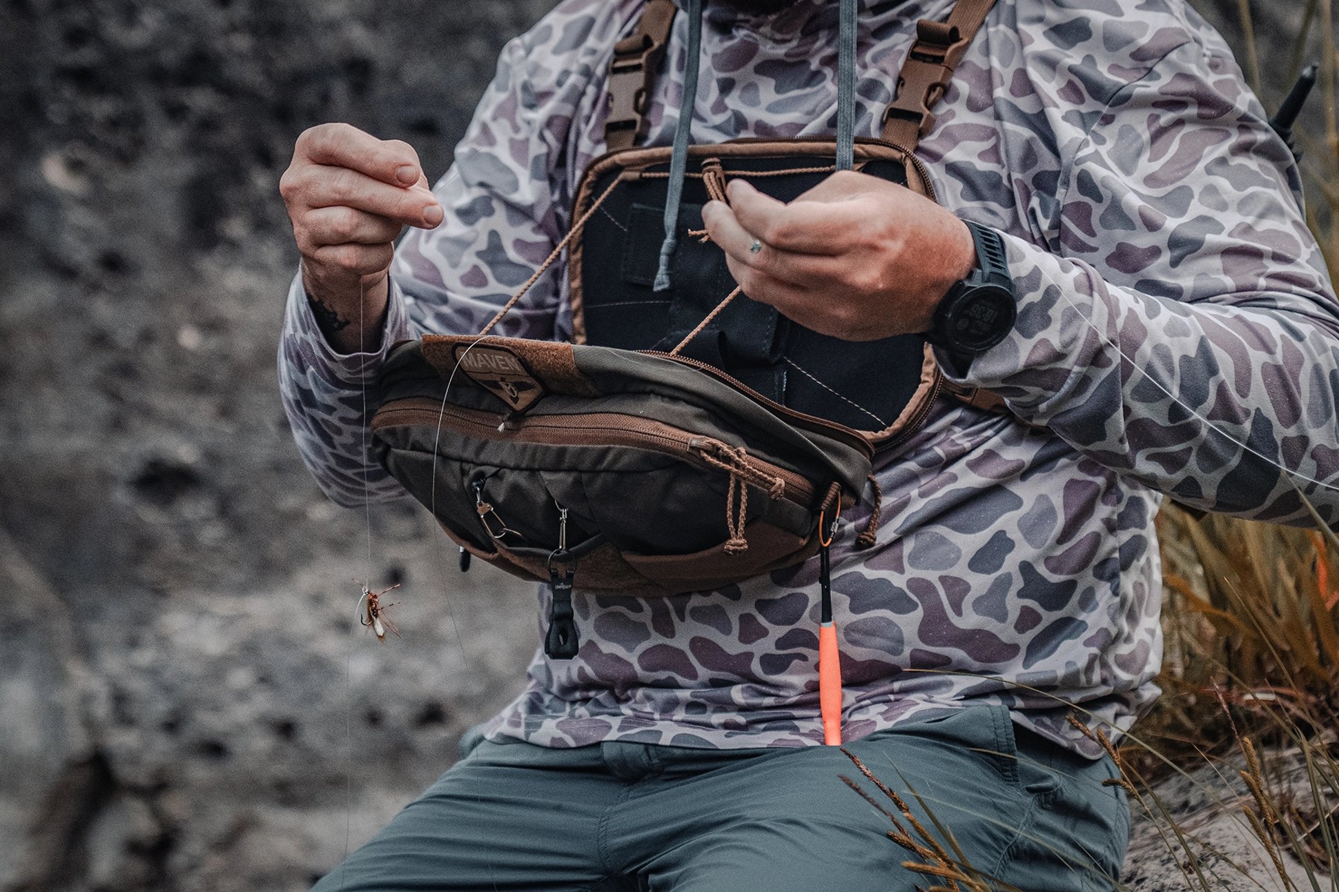a fly angler wearing the Kifaru Steelhead Chest Rig with the Kifaru Hydro Harness with rear pouch open