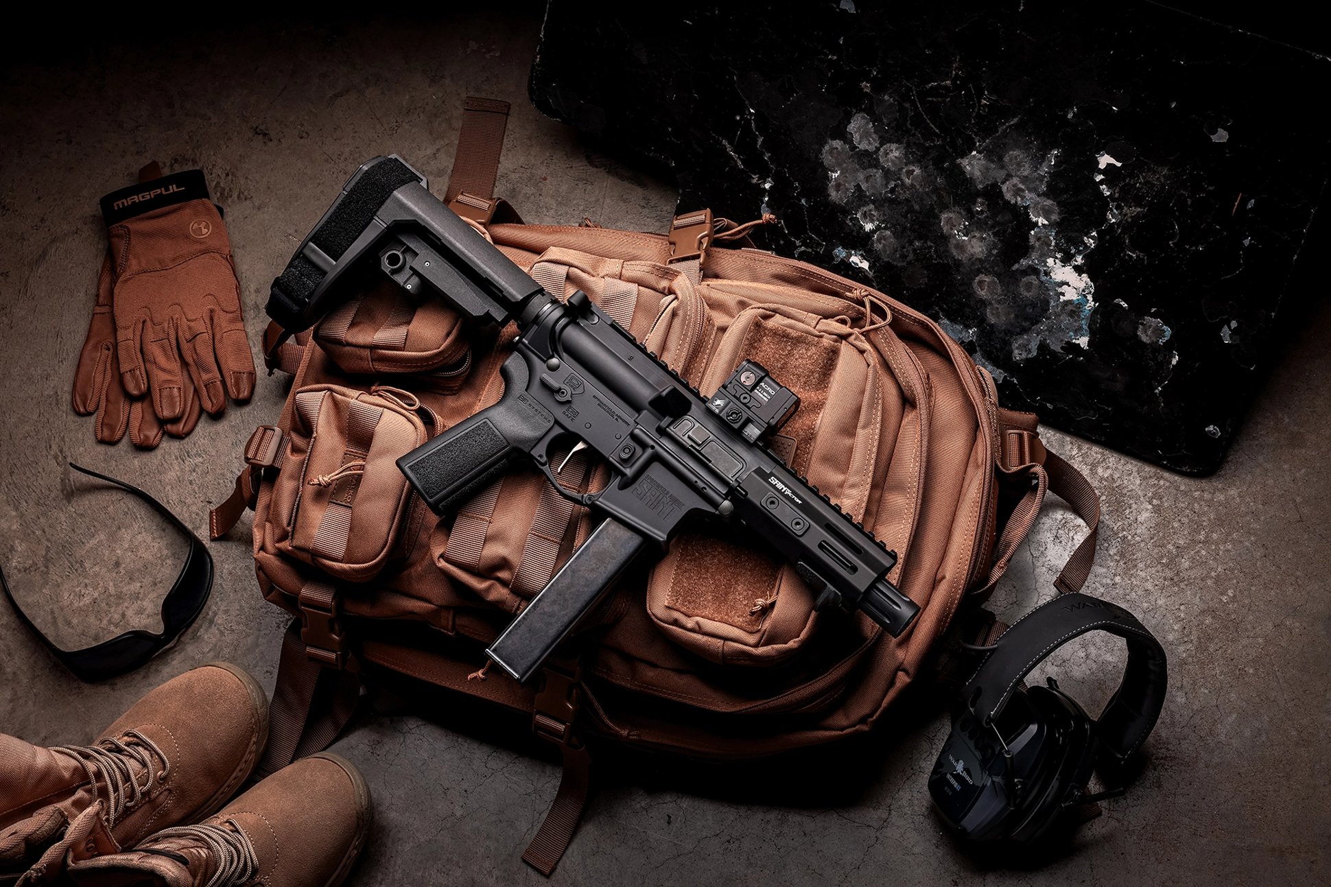 The Springfield Armory 9mm Saint Victor pistol on a backpack with assorted gear