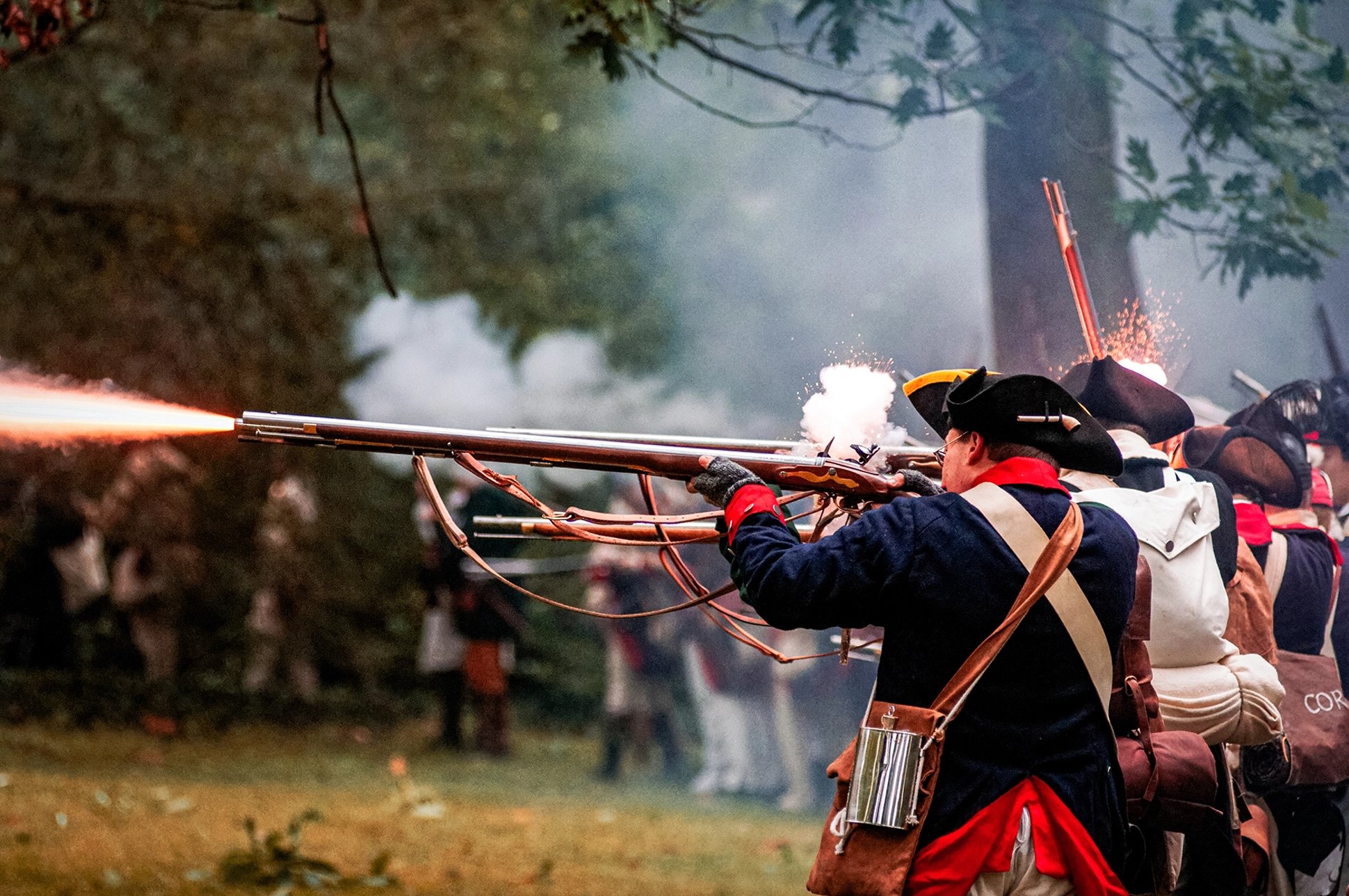 revolutionary war reenactors firing muskets