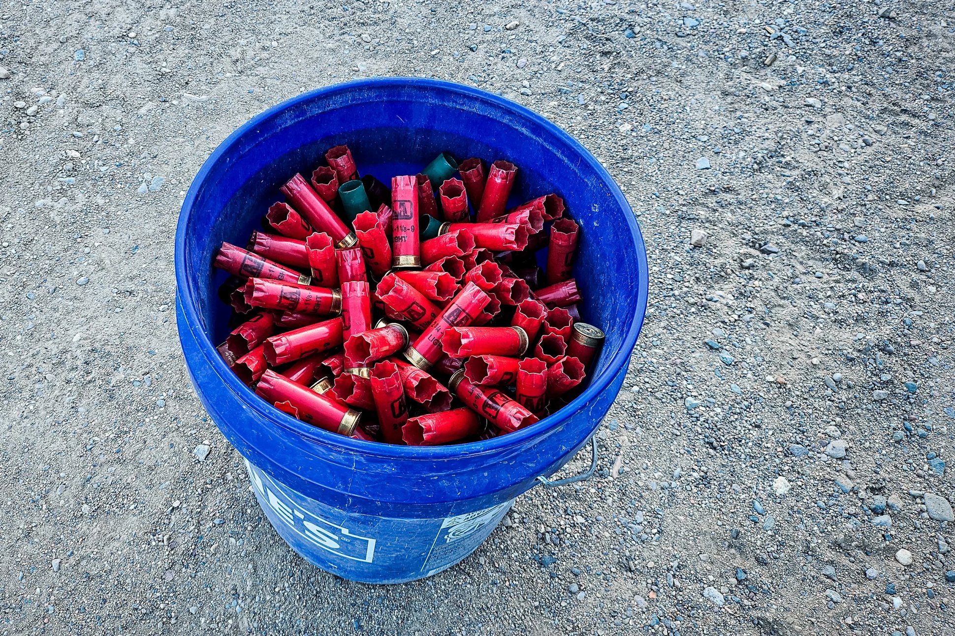 a bucket of spent shotgun shells