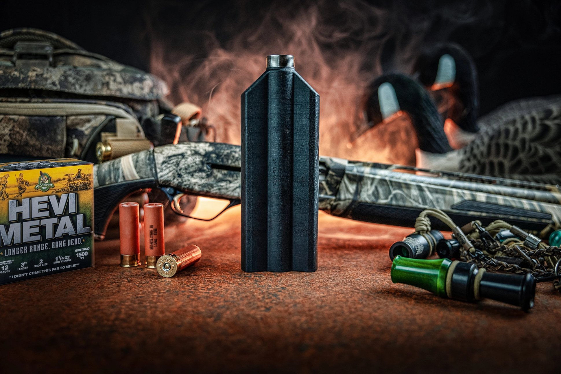 suppressor with a shotgun, ammo, an duck calls