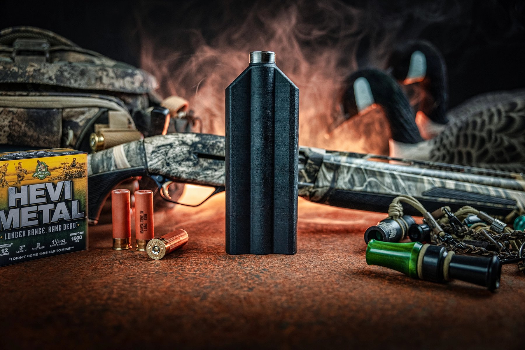 suppressor with a shotgun, ammo, an duck calls