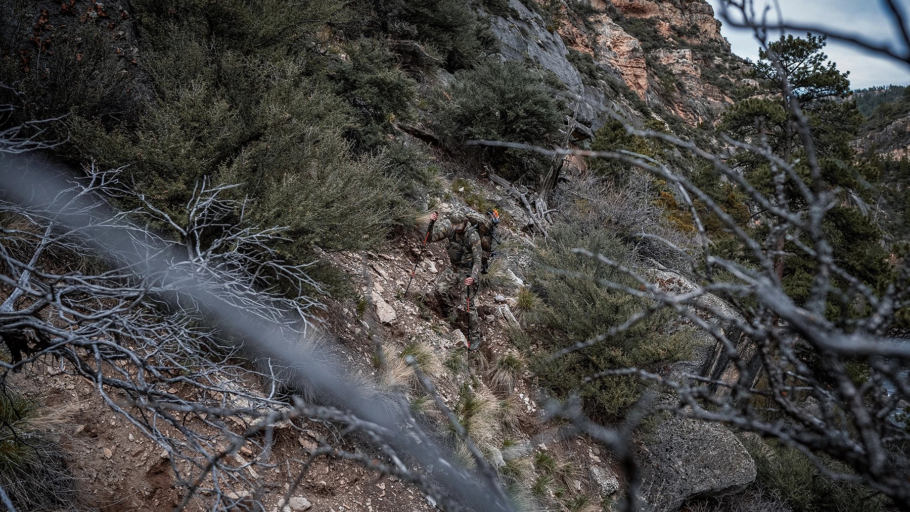 KUIU camo patterns a hunter hiking through sagebrush