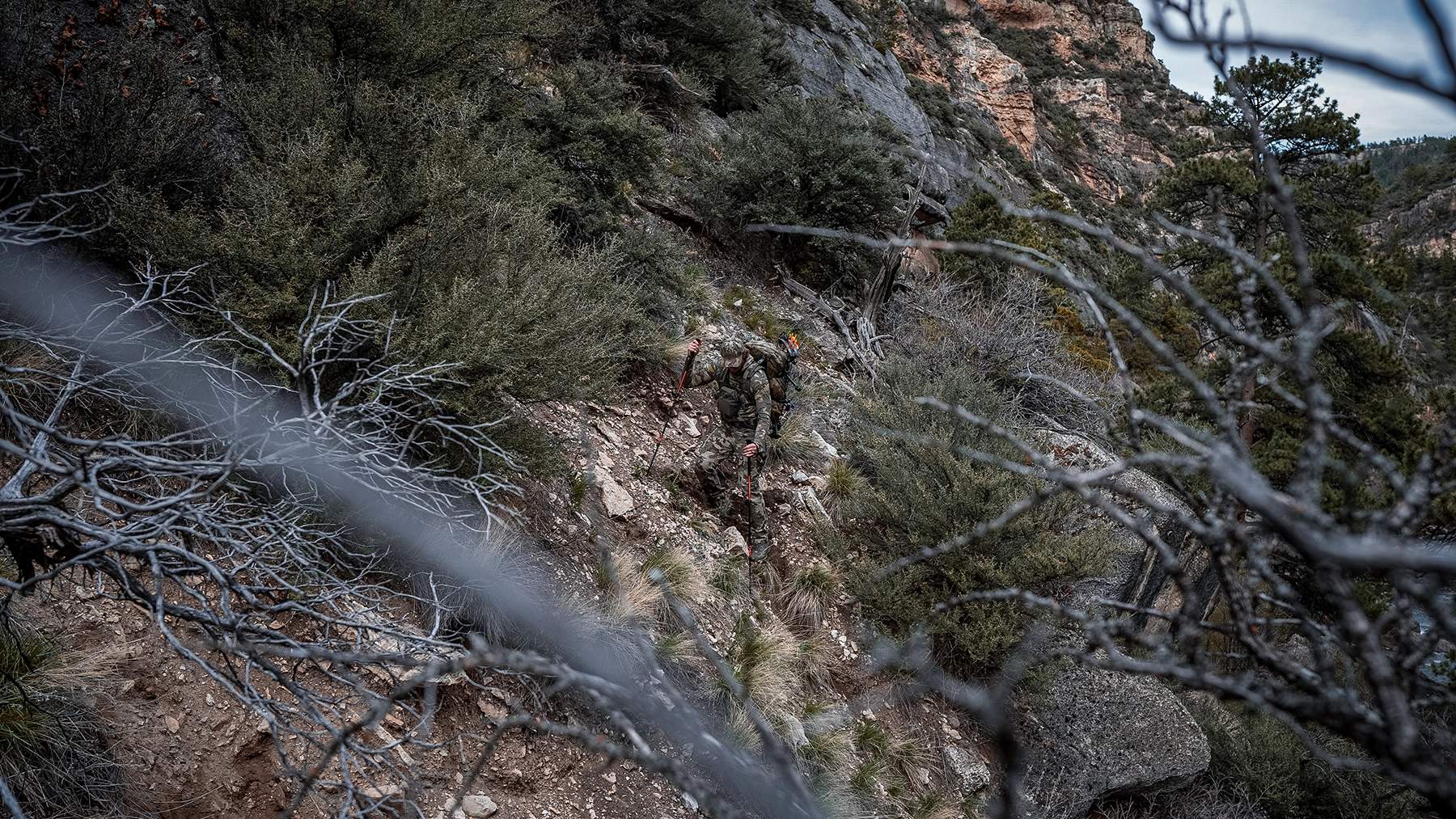KUIU camo patterns a hunter hiking through sagebrush