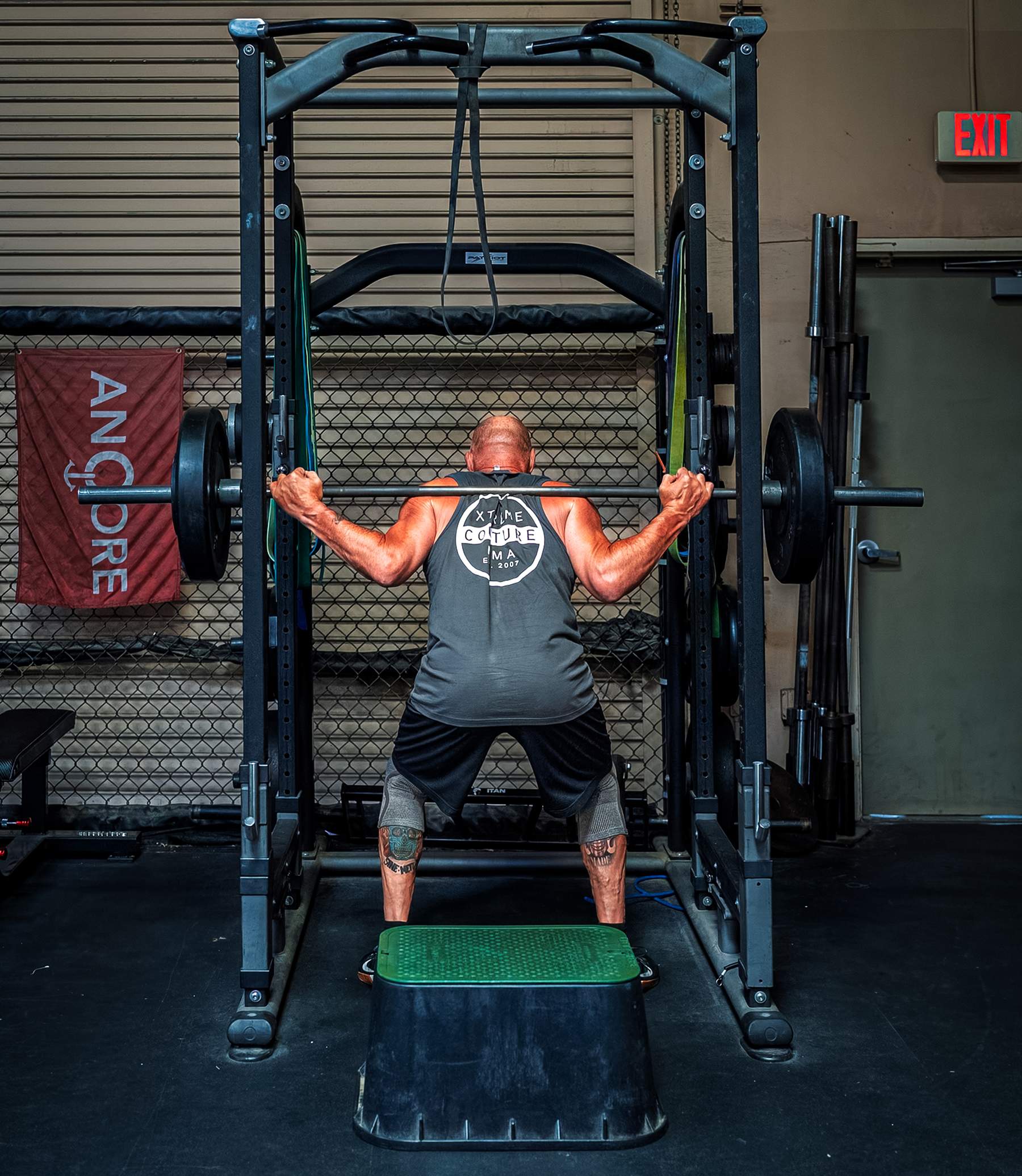 Randy Couture doing squats in a squat rack
