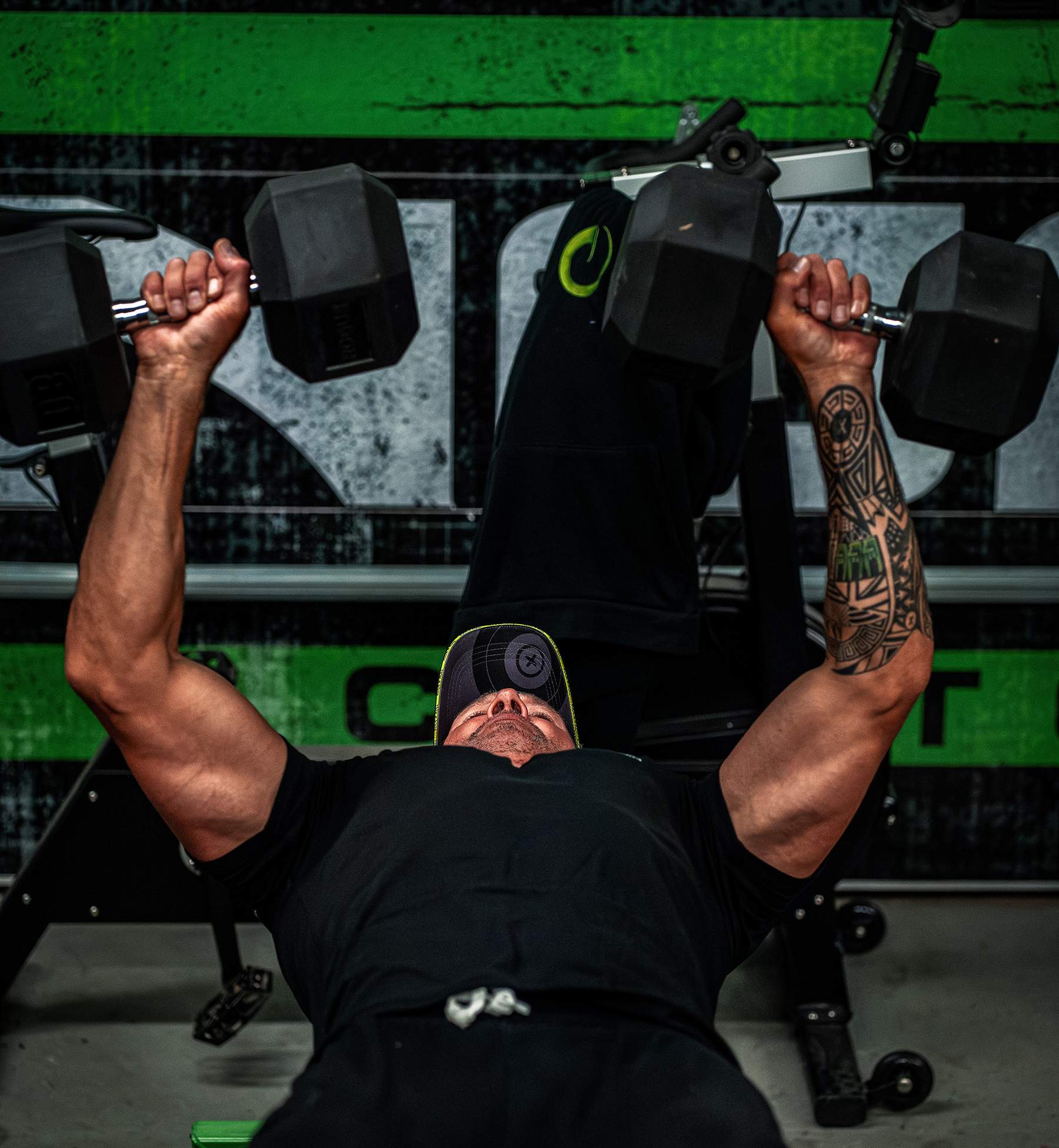 John Dudley doing dumbbell presses