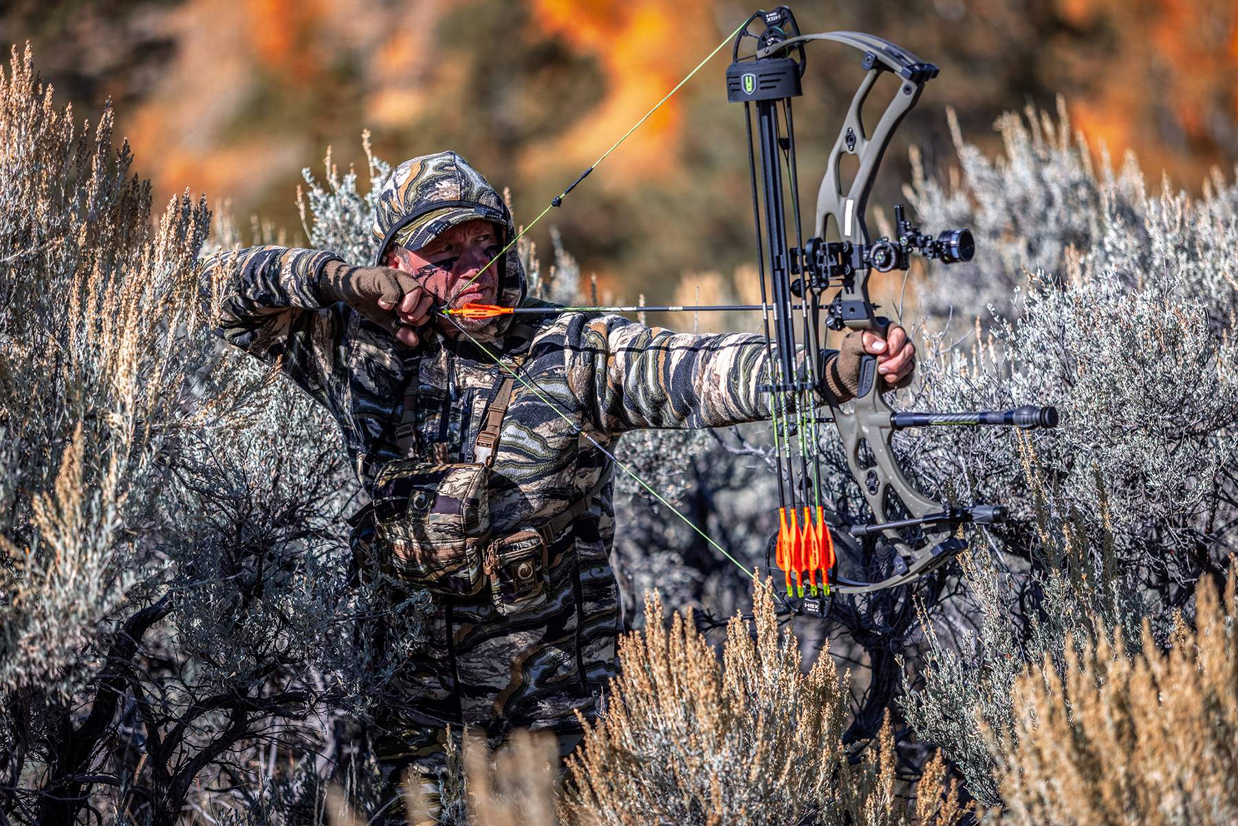 John Dudley at full draw in the sagebrush