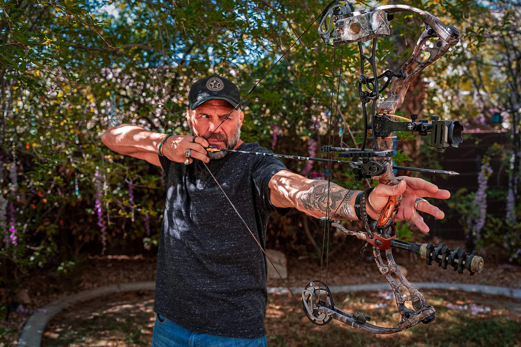 Randy Couture at full draw with a compound bow
