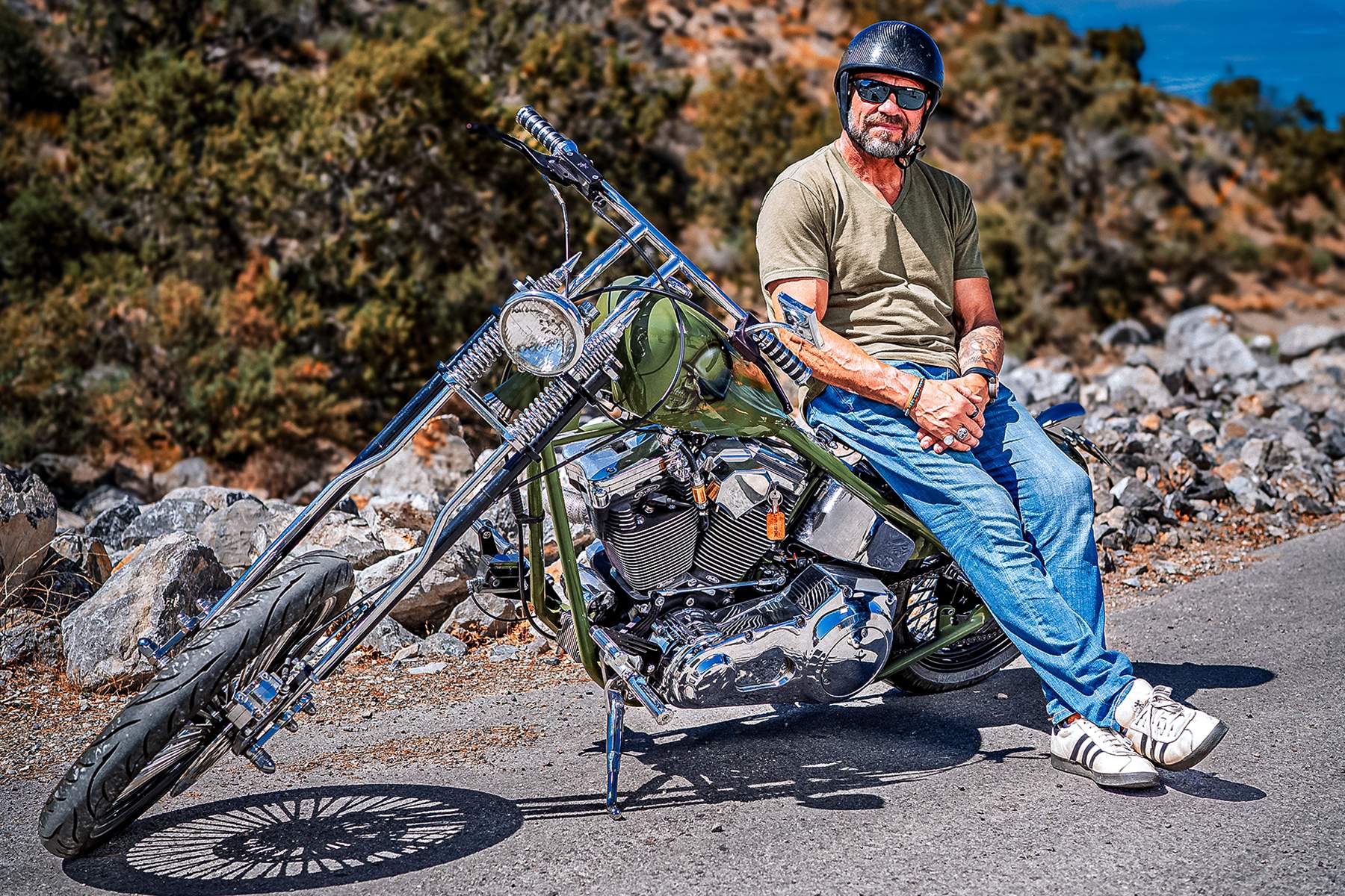 Randy Couture leadning on his custom motorcycle