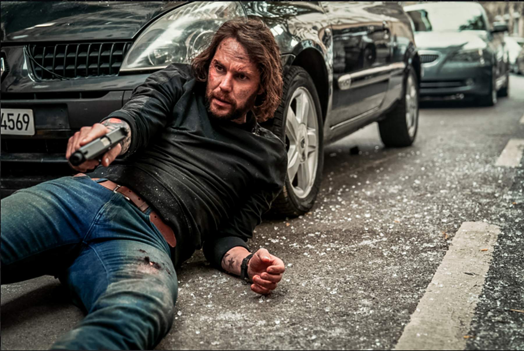 Taylor Kitsch with a pistol as Ben Edwards in The Terminal List: Dark Wolf