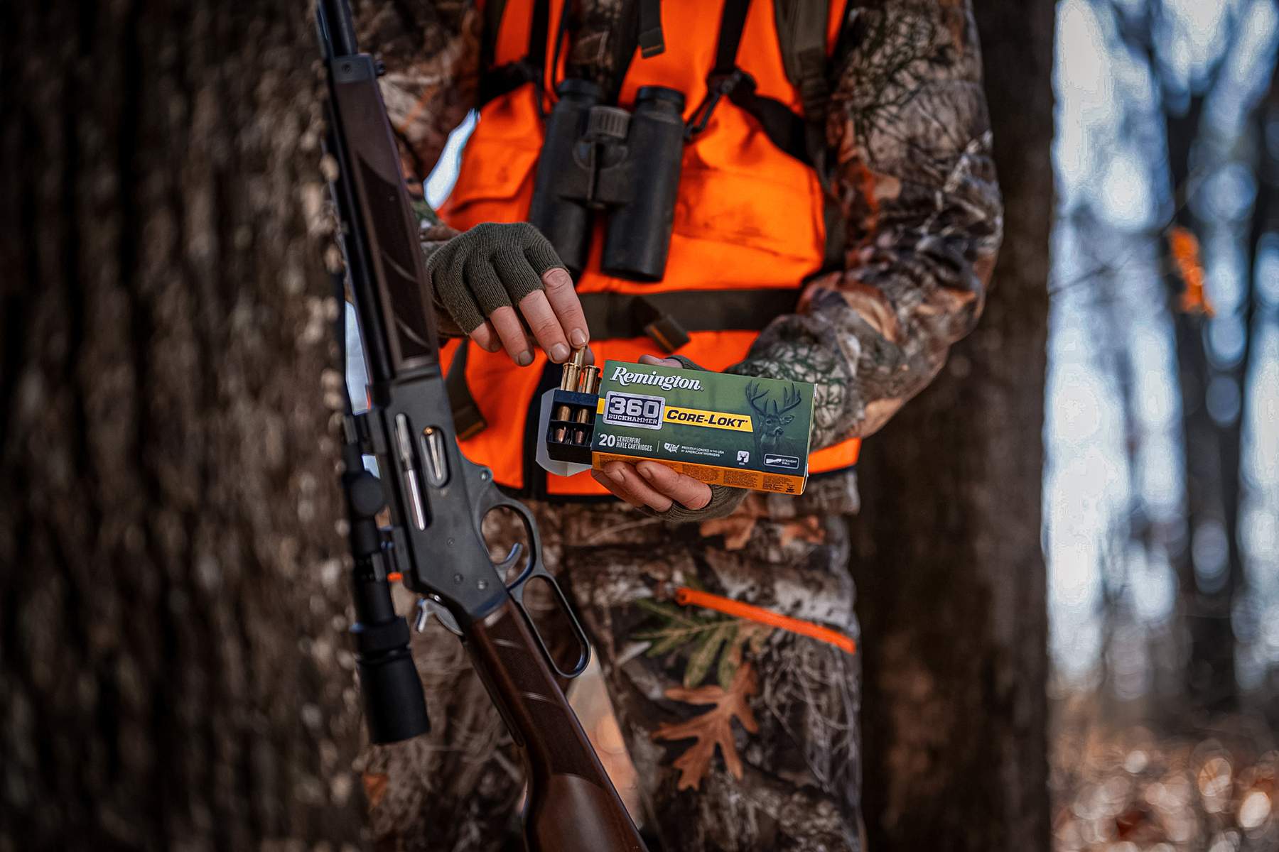a hunter pulling rounds of Remington Core-Lokt .360 buckhammer ammo from a box