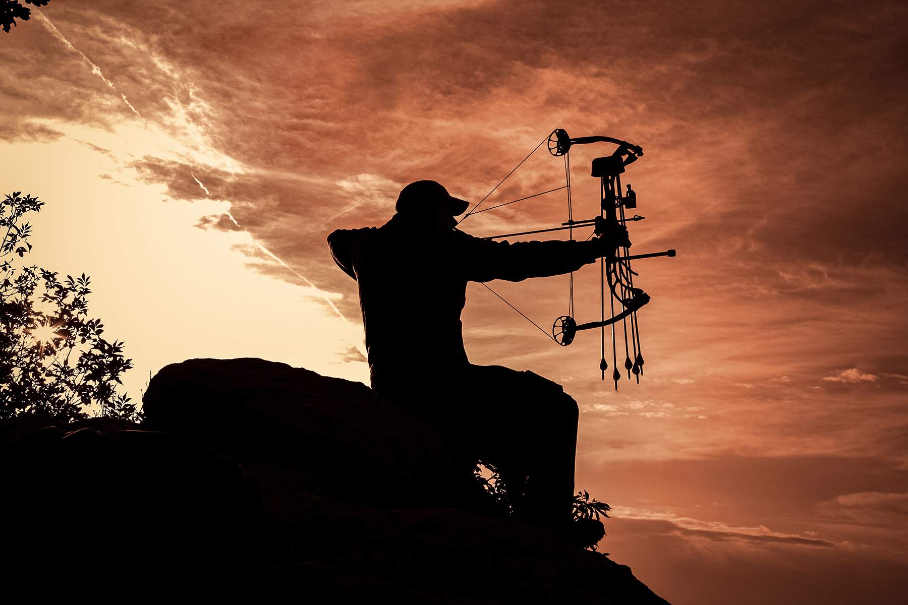 silhouette of a bowhunter with compound bow