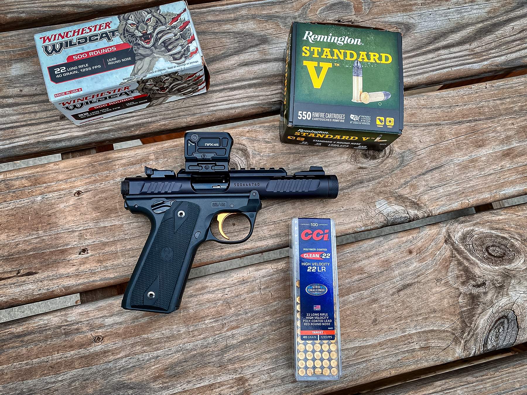 Ruger Mark IV 22/45 Lite with various .22LR ammo in boxes