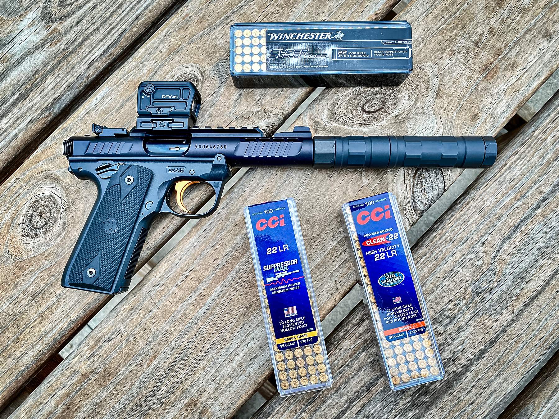 Ruger Mark IV 22/45 Lite with various .22LR ammo in boxes including Winchester and CCI