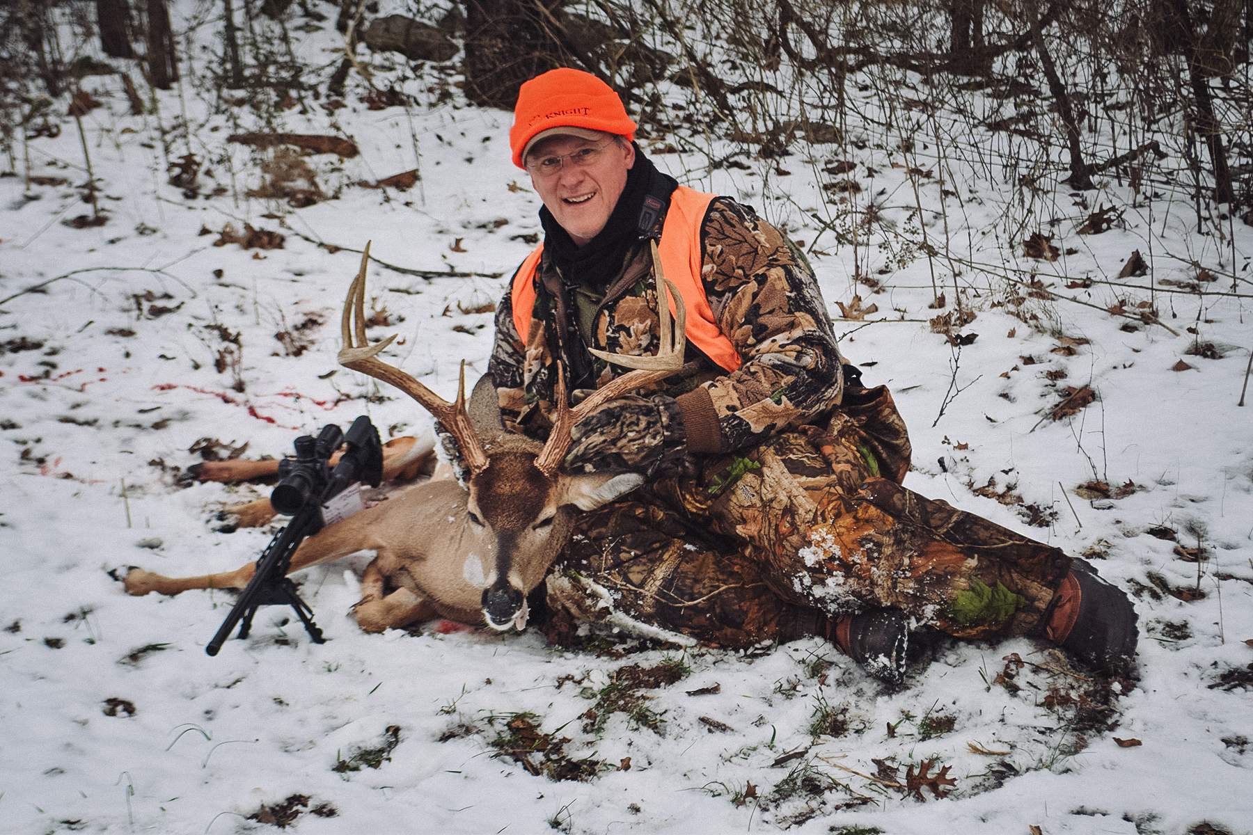 Barnes Harvest hunting ammunition a hunter with a large buck