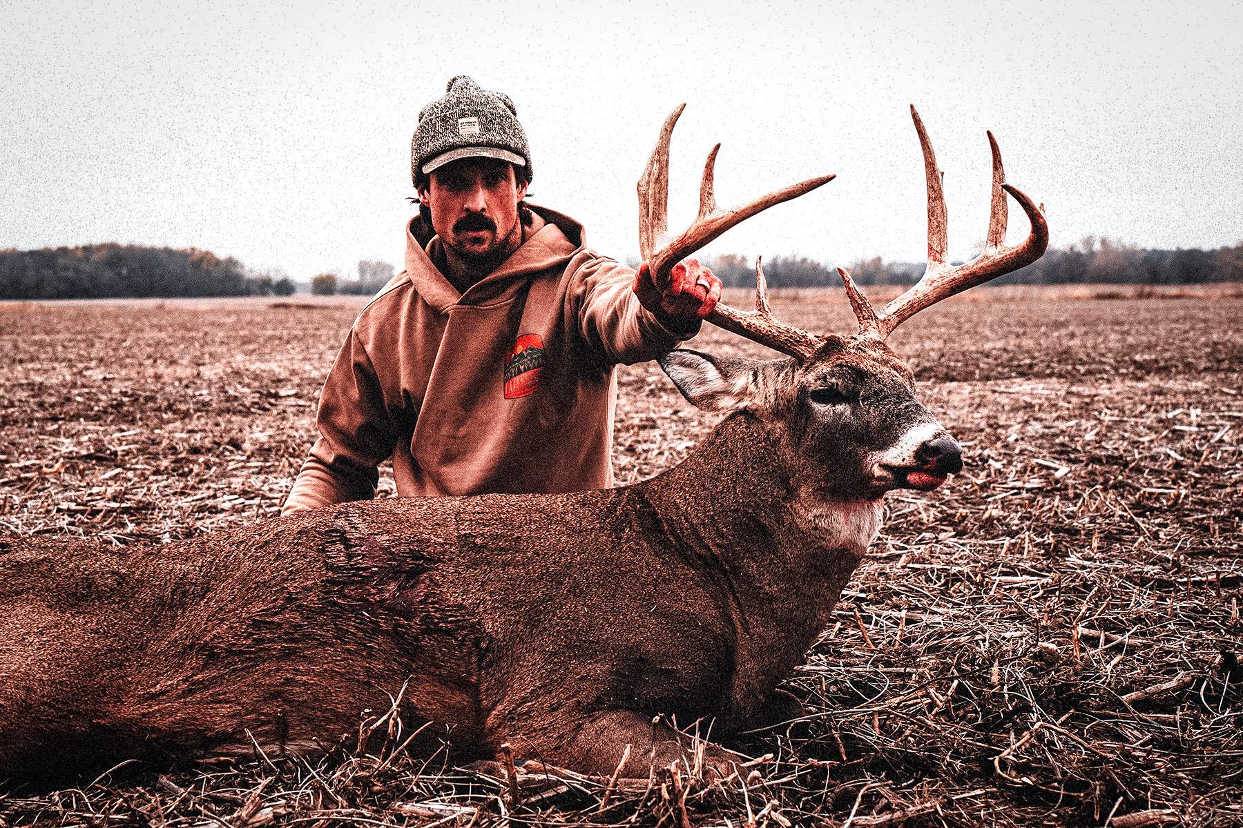 a hunter with a nice whitetail buck