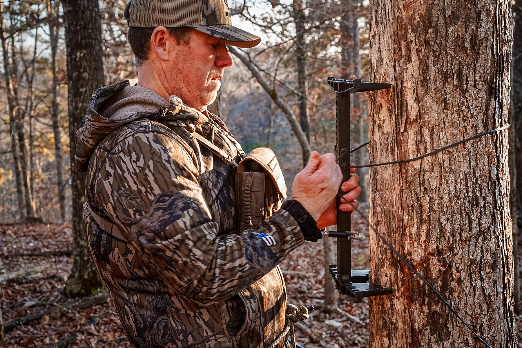 a hunter setting up a hunting saddle