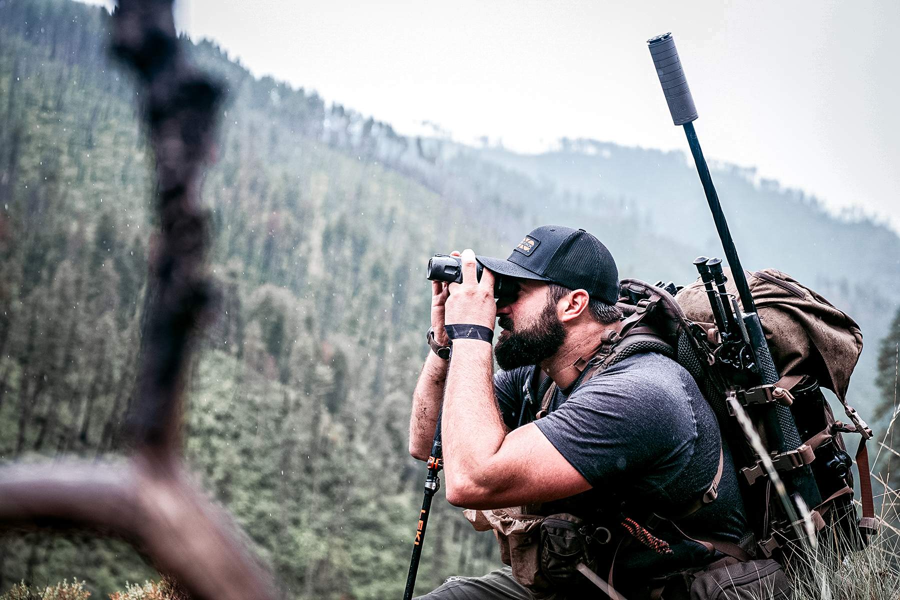hunter with a SilencerCo Scythe-Ti suppressor topped rifle in his pack
