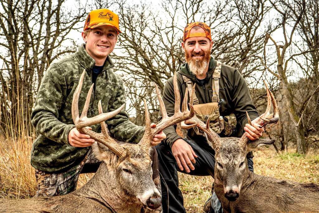 Adam LaRoche with his son and two giant whitetails