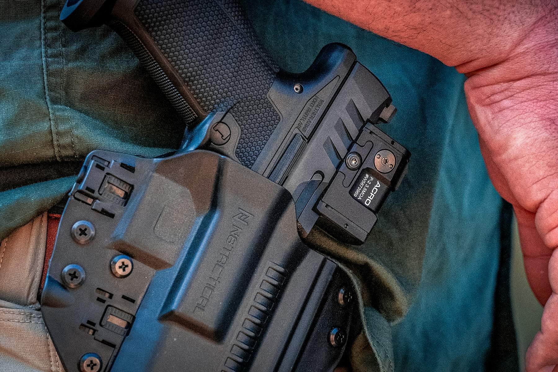 the walther in a holster with an ACRO red dot installed