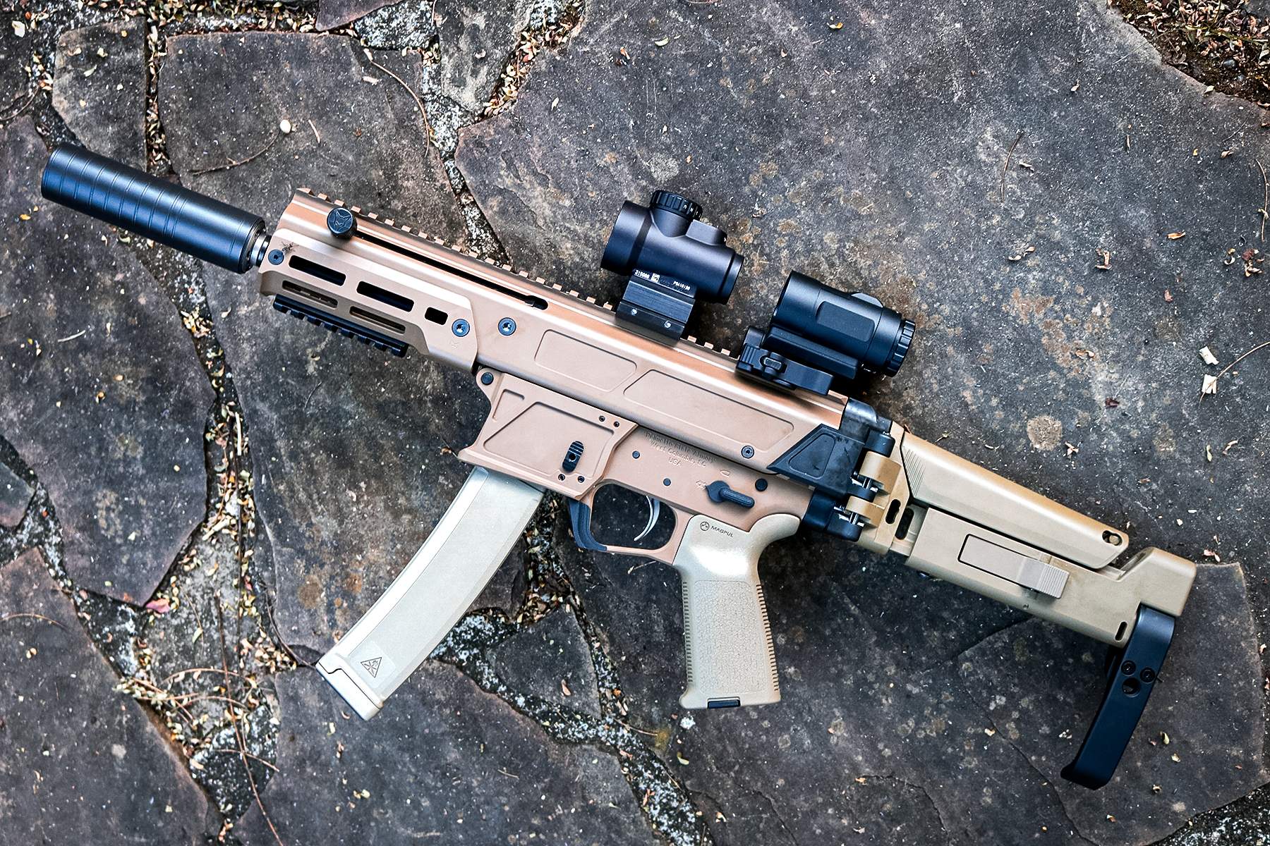 PSA JAKL 9 outfitted with a red dot and magnifier, suppressors, and pistol brace