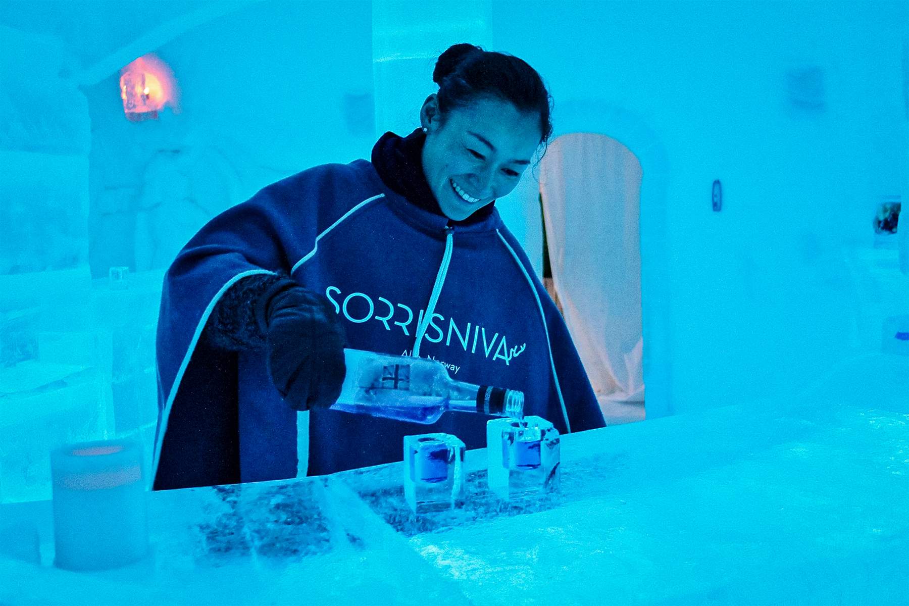 Bartender pouring drinks at the Sorrisniva Igloo Hotel and Ice Bar
