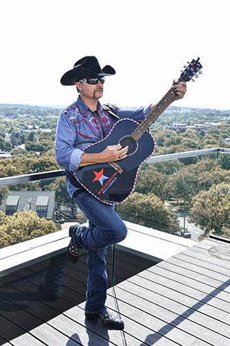 John Rich playing the guitarJohn Rich: Building His Rich Legacy